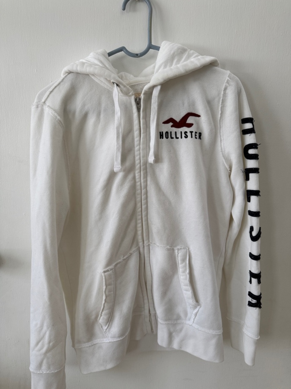 Hollister White Zip Hoodie with Maroon Logo and Black Sleeve Text